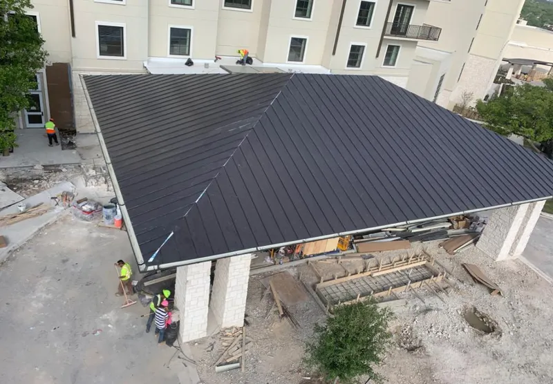 Metal roofing installation team working on a commercial building in Wappinger